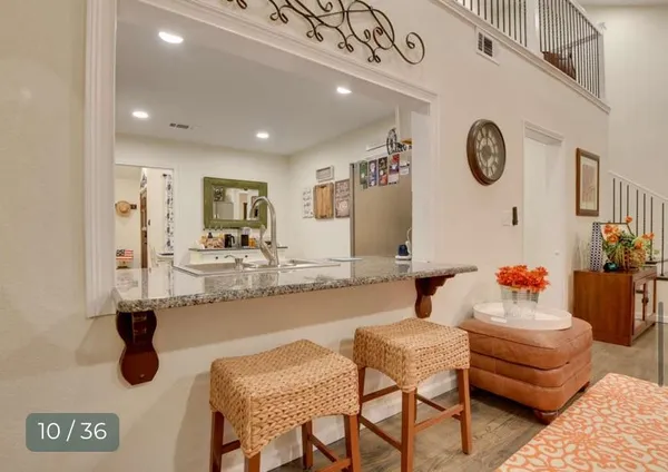 a living room with furniture ceiling fan and a rug