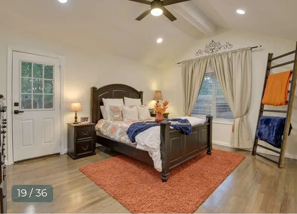 a living room with furniture and a ceiling fan