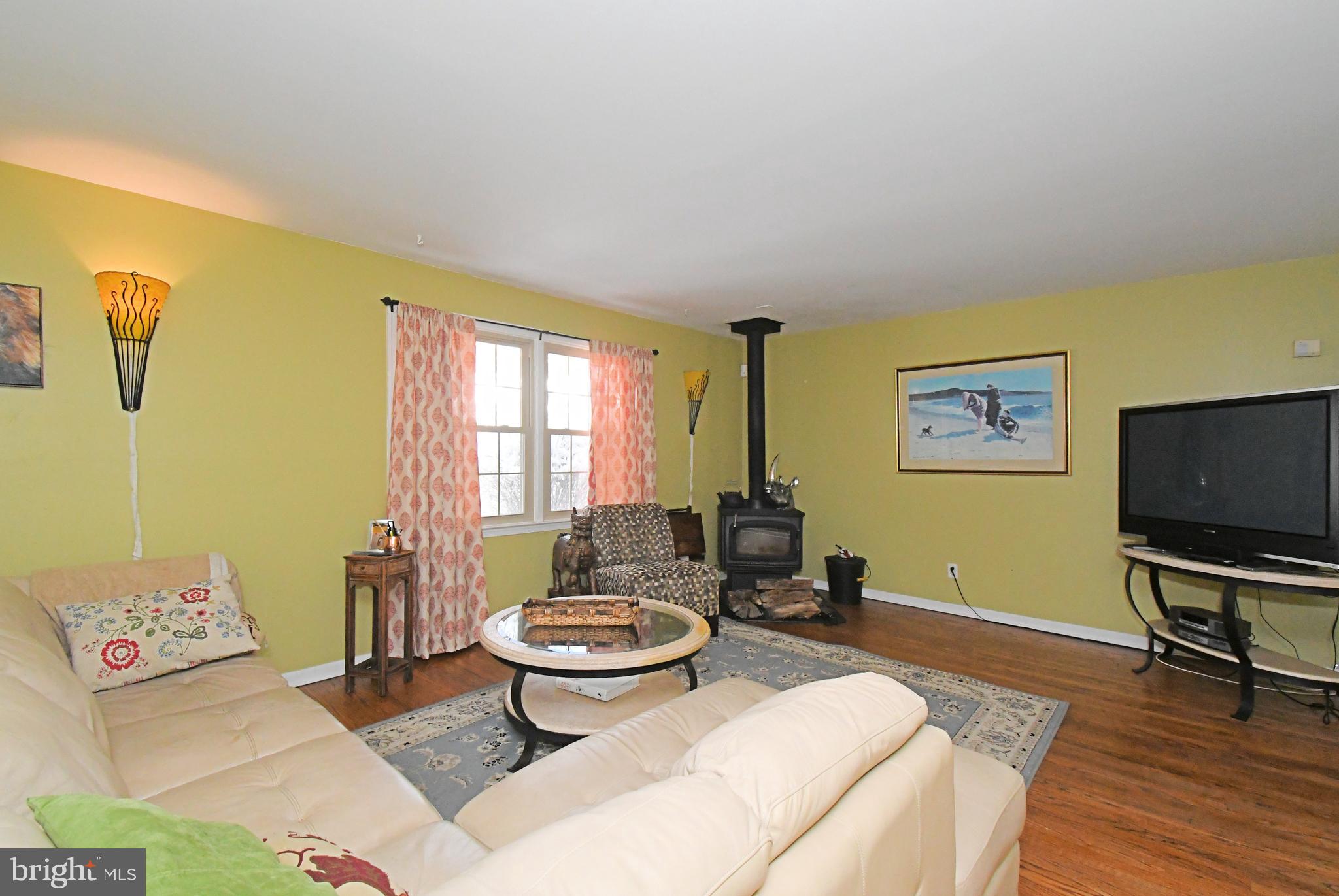 1113 Clark Road Wyndmoor, PA 19038 - Photo 15 of 68 a living room with furniture a flat screen tv and a window