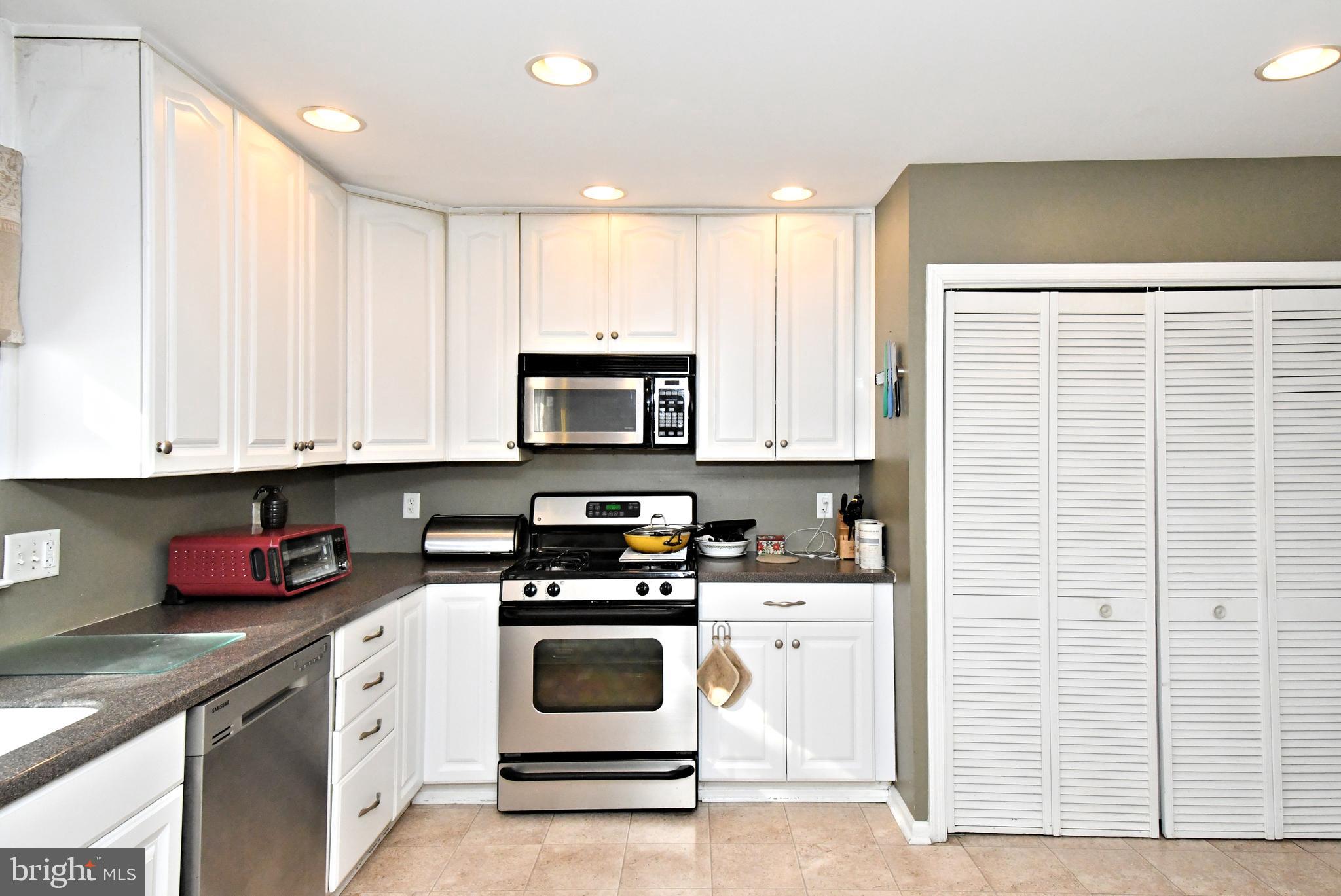 1113 Clark Road Wyndmoor, PA 19038 - Photo 25 of 68 a kitchen with stainless steel appliances granite countertop a stove a sink and a microwave