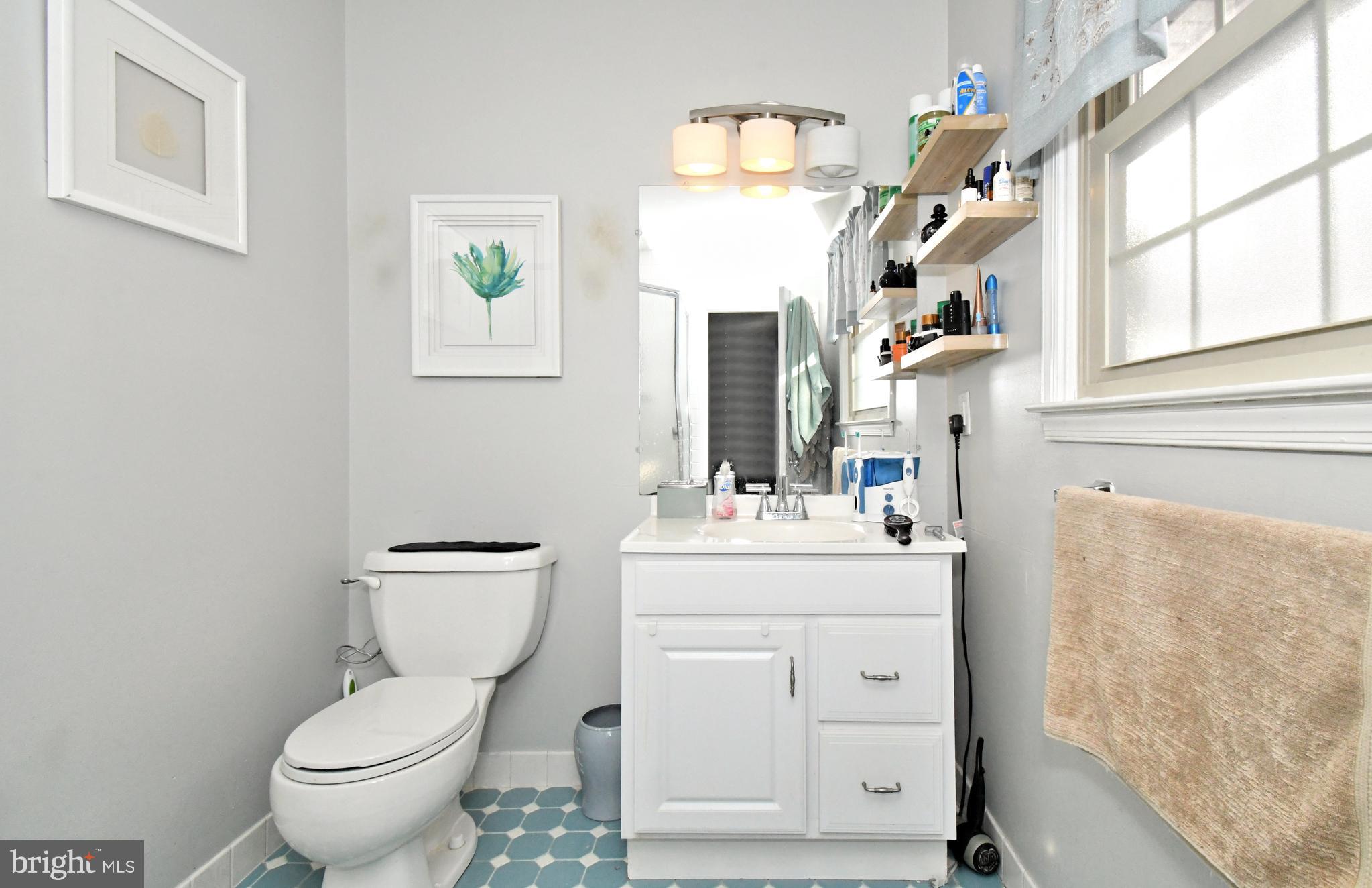 1113 Clark Road Wyndmoor, PA 19038 - Photo 33 of 68 a bathroom with a toilet sink and mirror