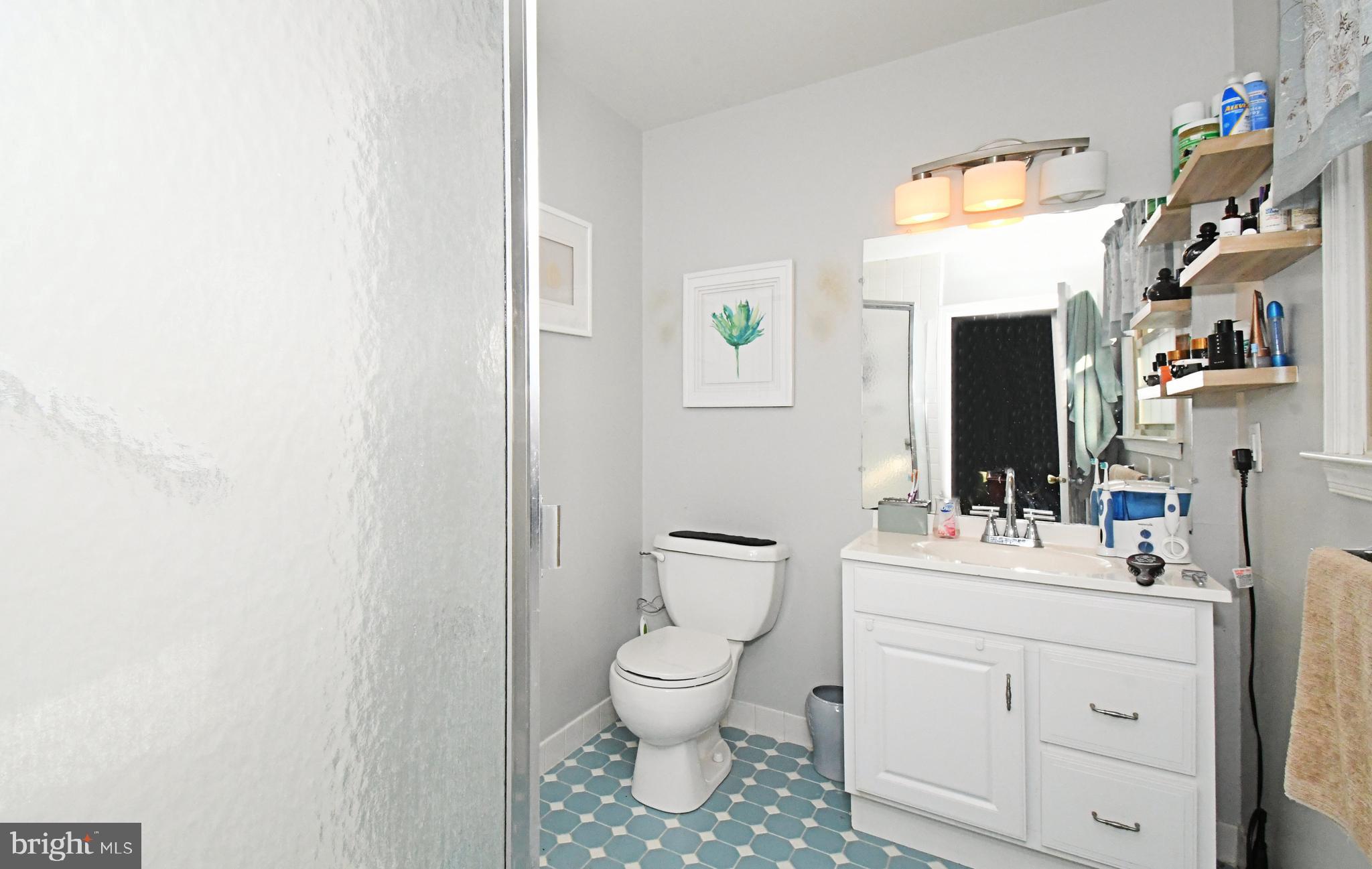 1113 Clark Road Wyndmoor, PA 19038 - Photo 34 of 68 a bathroom with a toilet sink vanity and mirror
