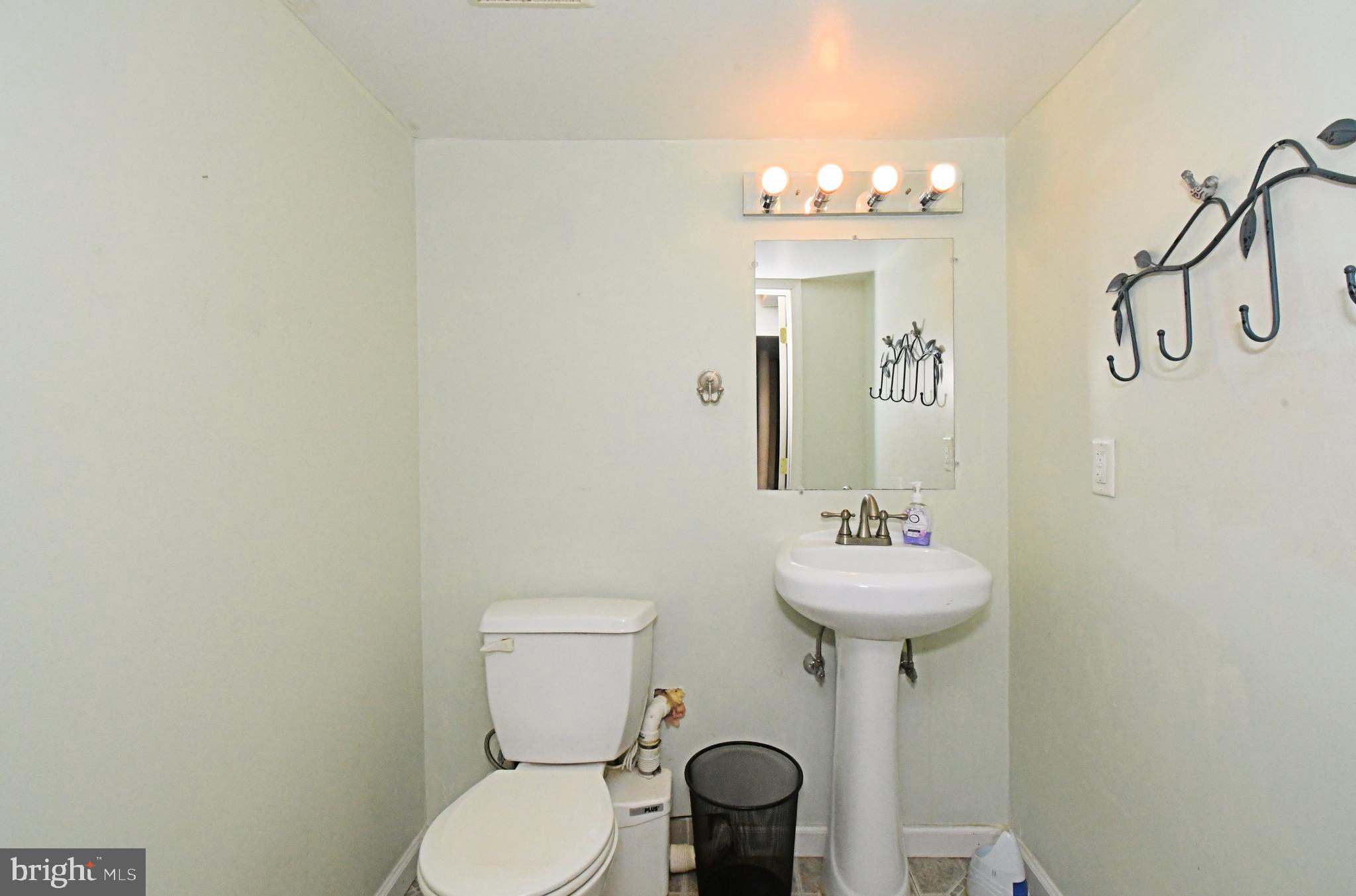 1113 Clark Road Wyndmoor, PA 19038 - Photo 48 of 68 a bathroom with a toilet sink and mirror