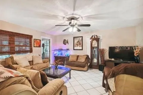 a kitchen with stainless steel appliances granite countertop a stove top oven a sink a dining table and chairs with wooden floor