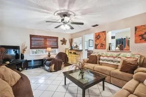 a kitchen with granite countertop a refrigerator and a stove top oven