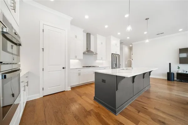 a kitchen with kitchen island white cabinets and sink