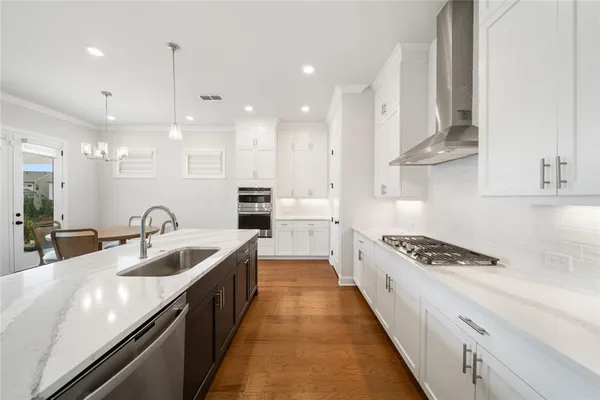 a kitchen with counter top space a sink stainless steel appliances and cabinets