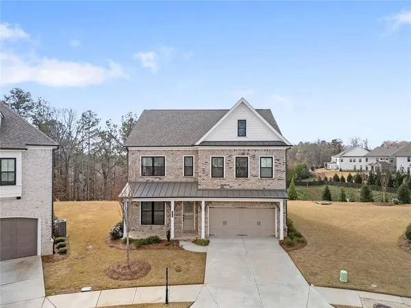 a front view of a house with a yard