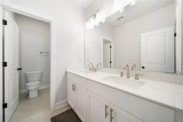 a bathroom with a toilet and shower