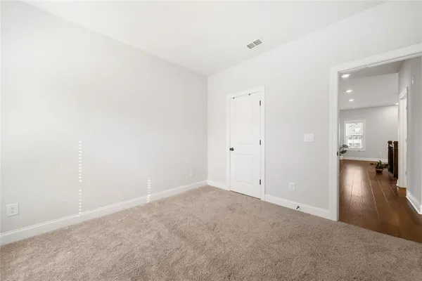 a spacious bedroom with a bed and a window