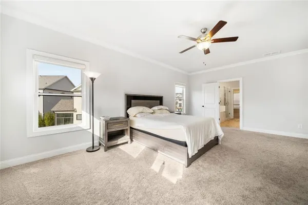 a spacious bedroom with a bed and a chandelier