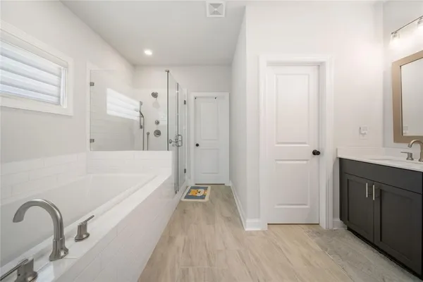 a spacious bathroom with a double vanity sink double and mirror