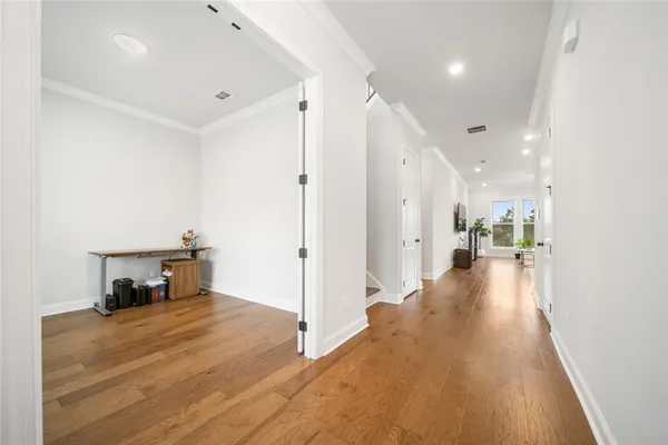 a view of a living room hardwood floor and a kitchen