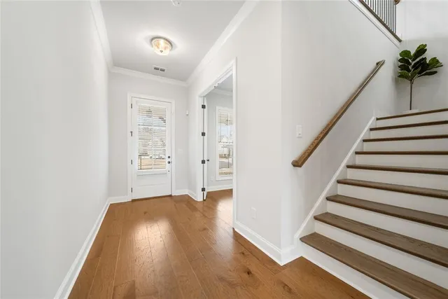 a view of a room with a window and wooden floor