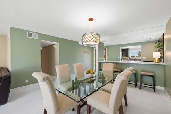 a hallway with a furniture and a kitchen