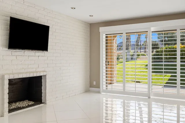 a living room with a flat screen tv and a fireplace