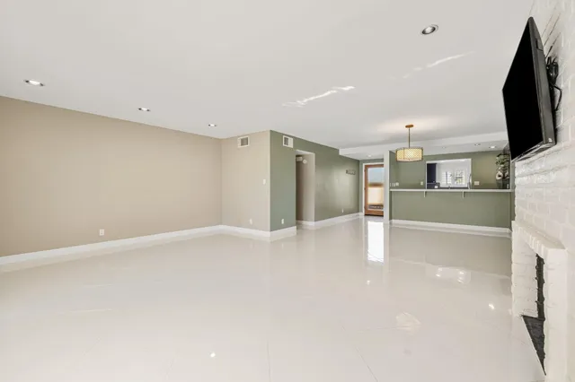 a view of a kitchen with a refrigerator a microwave and a sink