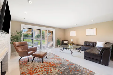 a bathroom with a granite countertop sink a toilet and a mirror