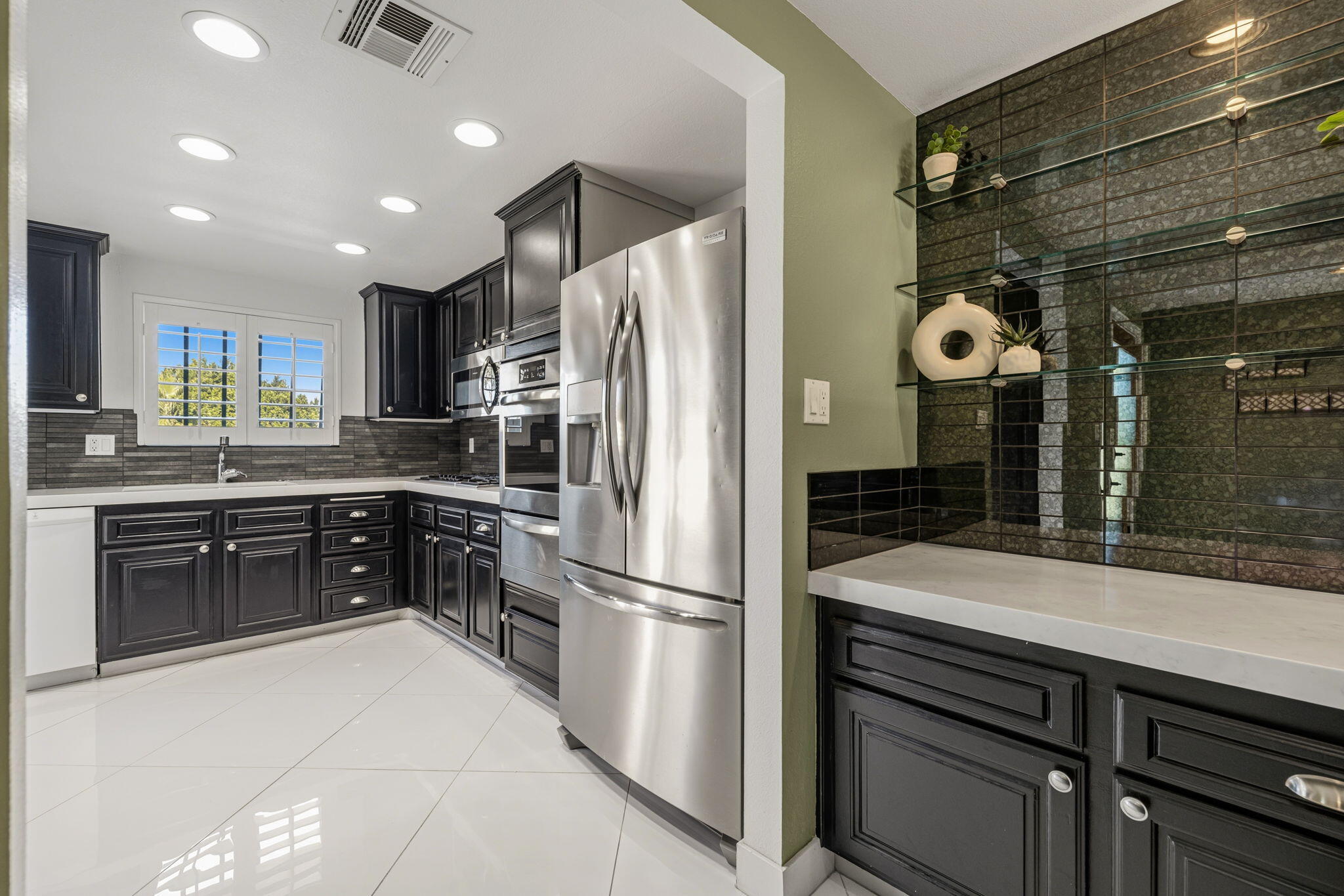 72915 Homestead Road Palm Desert, CA 92260 - Photo 5 of 45 a kitchen with a refrigerator and a sink
