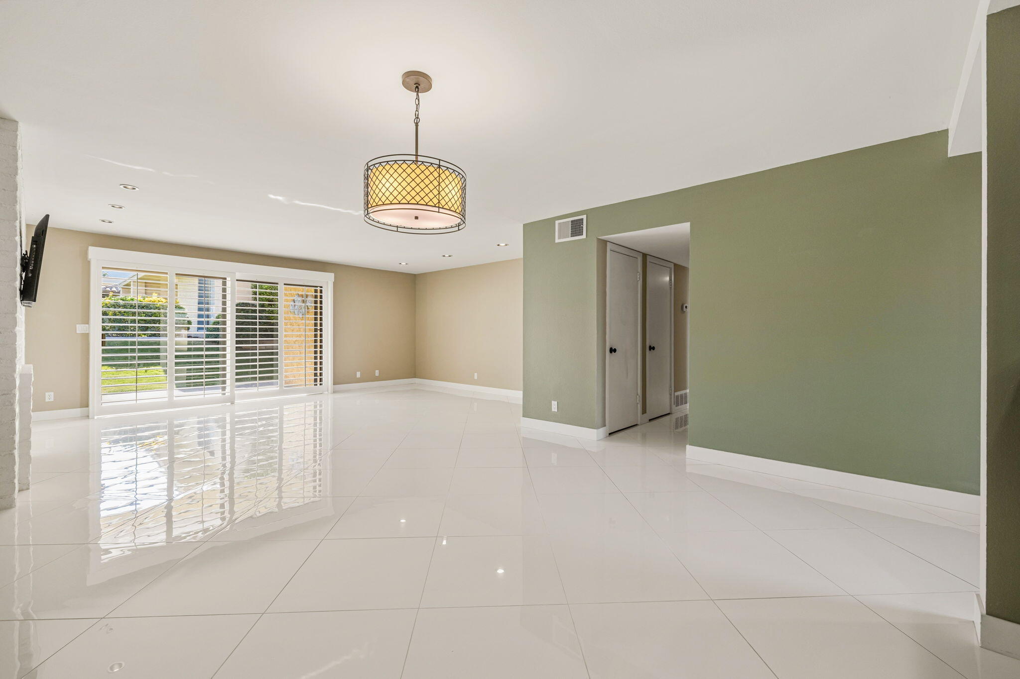 72915 Homestead Road Palm Desert, CA 92260 - Photo 8 of 45 a view of an empty room with window and chandelier fan