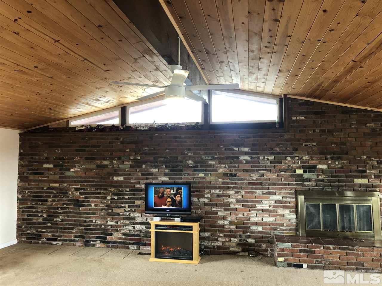 170 Redstone Drive Reno, NV 89512 - Photo 6 of 17 a view of an empty room with a fireplace