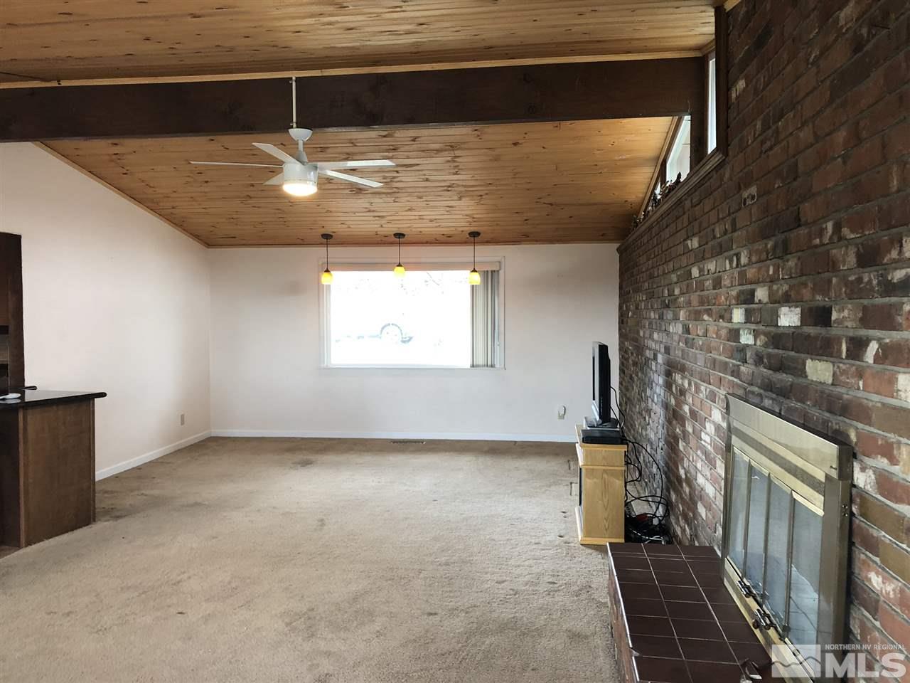 170 Redstone Drive Reno, NV 89512 - Photo 7 of 17 a view of an empty room with a fireplace