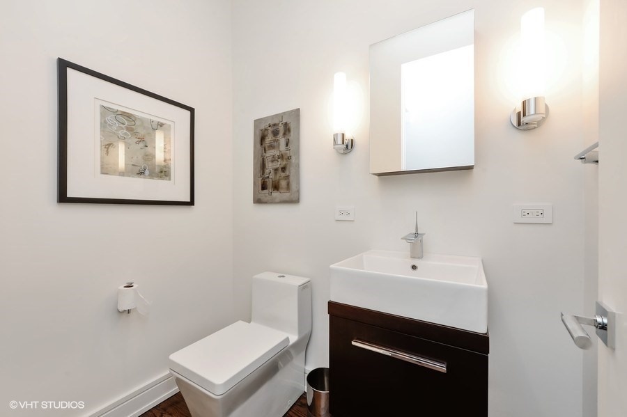 1439 North Dearborn Street, Unit 2 Chicago, IL 60610 - Photo 15 of 18 a bathroom with a toilet a sink and mirror