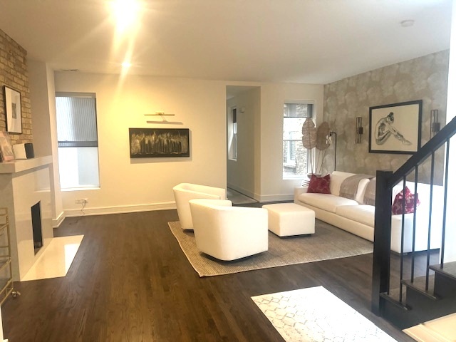 1439 North Dearborn Street, Unit 2 Chicago, IL 60610 - Photo 4 of 18 a living room with furniture and a fireplace