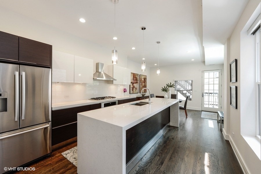 1439 North Dearborn Street, Unit 2 Chicago, IL 60610 - Photo 5 of 18 a kitchen with stainless steel appliances a sink stove refrigerator and cabinets