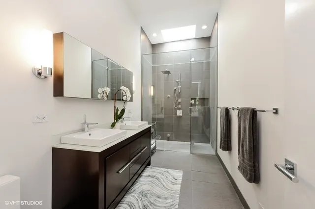 a bathroom with a double vanity sink and mirror