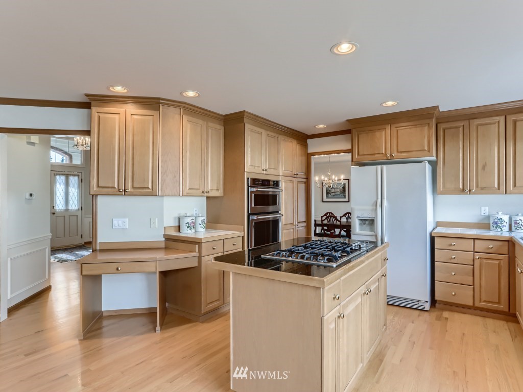 3007 215th Street Southeast Bothell, WA 98021 - Photo 11 of 28 a kitchen with stainless steel appliances kitchen island granite countertop a stove refrigerator and cabinets