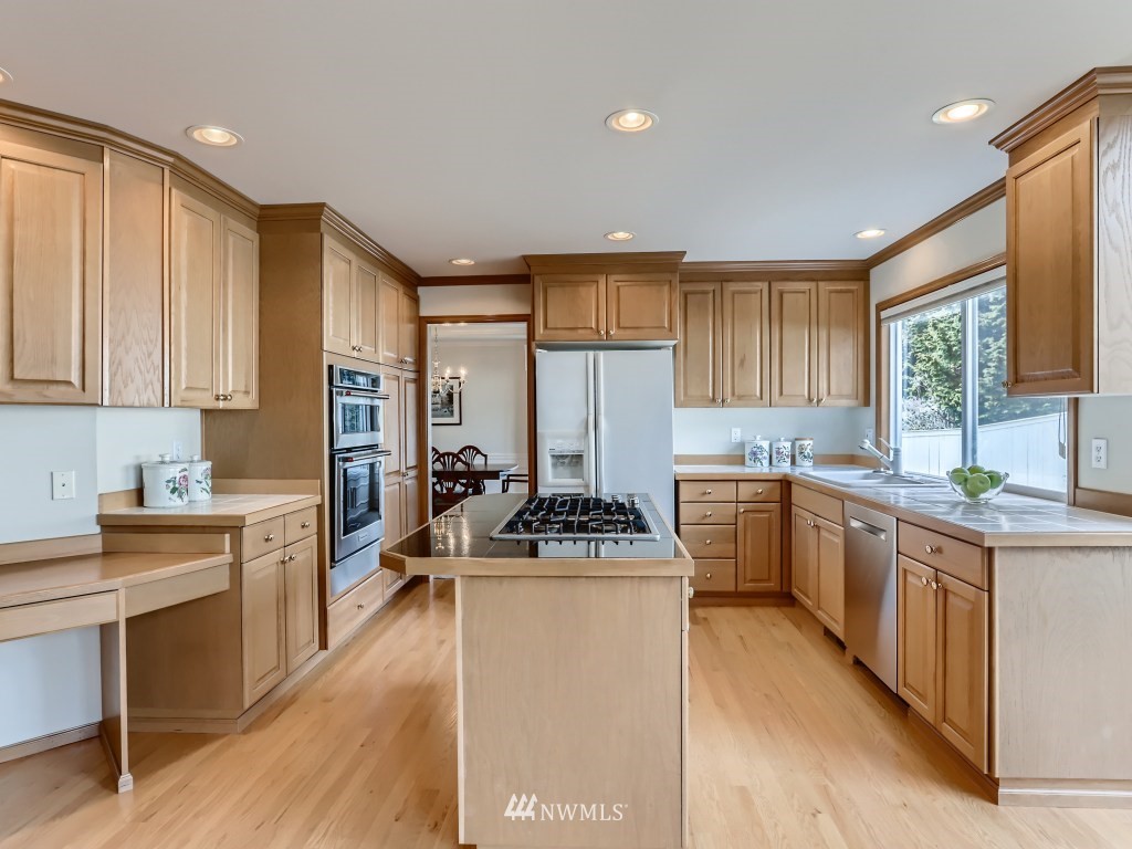 3007 215th Street Southeast Bothell, WA 98021 - Photo 12 of 28 a kitchen with a stove a sink a refrigerator and cabinets