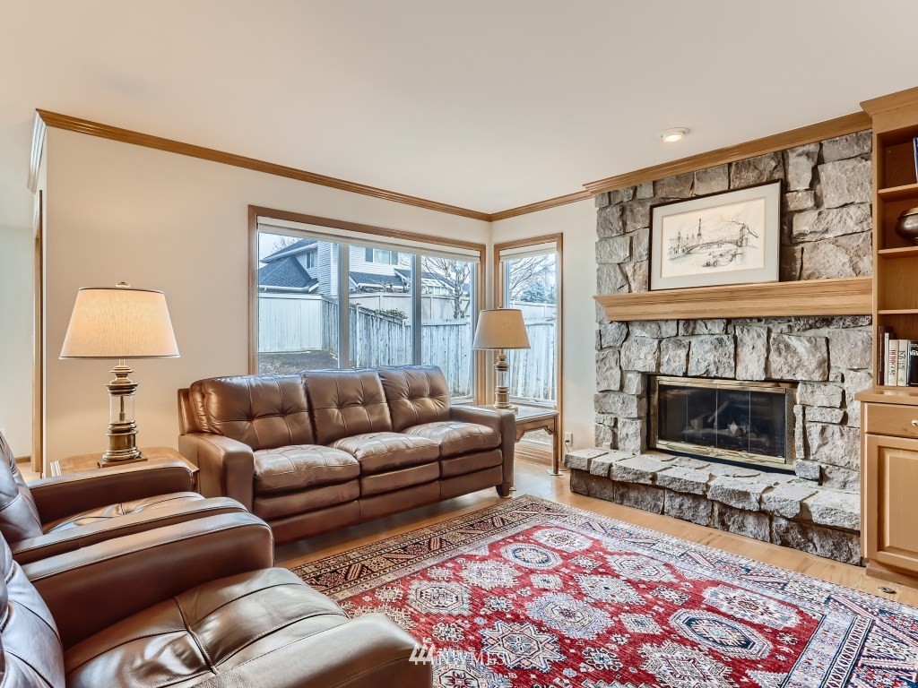 3007 215th Street Southeast Bothell, WA 98021 - Photo 15 of 28 a living room with furniture and a fireplace