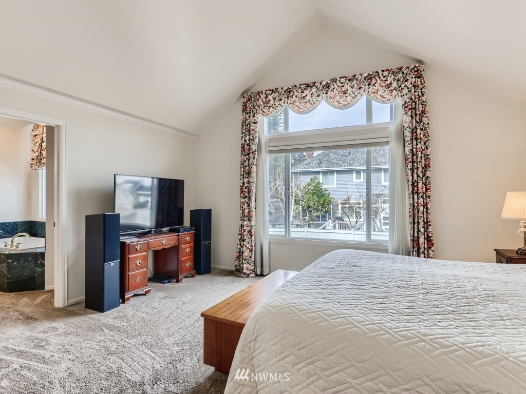 3007 215th Street Southeast Bothell, WA 98021 - Photo 19 of 28 a bedroom with a bed and a tv on table