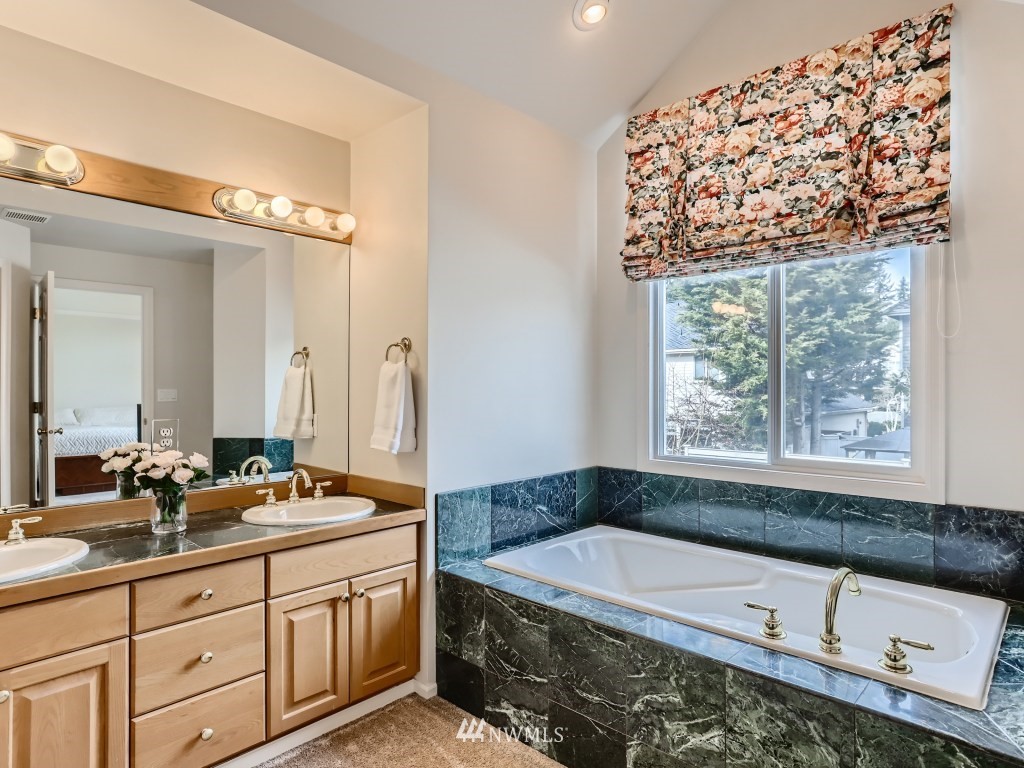 3007 215th Street Southeast Bothell, WA 98021 - Photo 20 of 28 a spacious bathroom with a bathtub a sink and a window