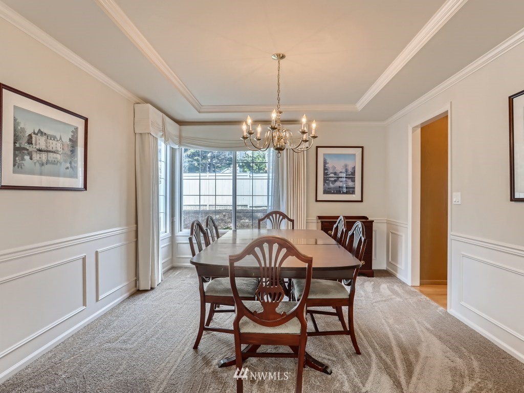 3007 215th Street Southeast Bothell, WA 98021 - Photo 9 of 28 a view of a dining room with furniture wooden floor and chandelier