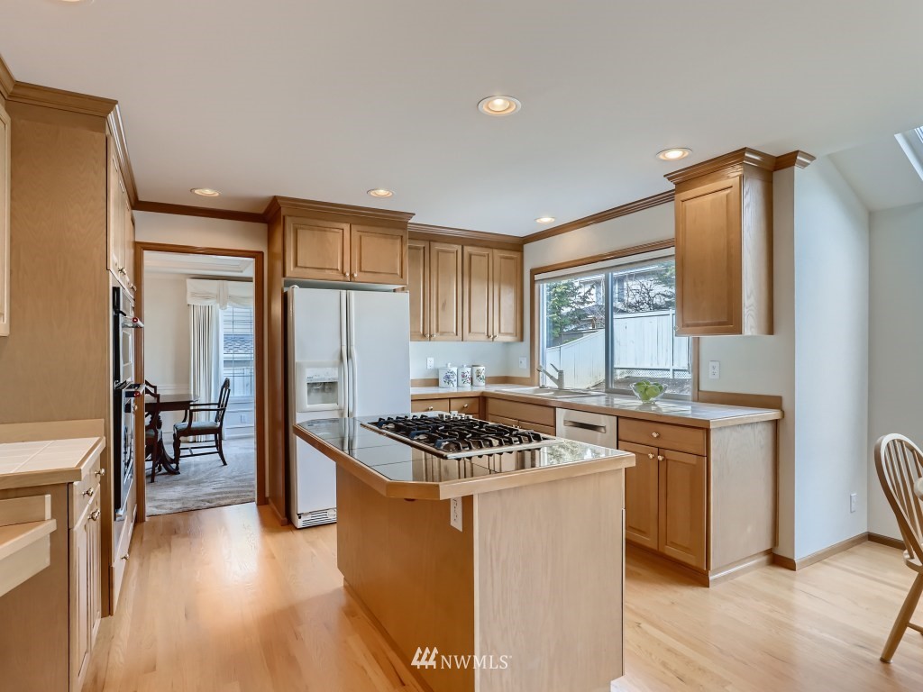 3007 215th Street Southeast Bothell, WA 98021 - Photo 10 of 28 a kitchen with stainless steel appliances granite countertop a stove a sink a refrigerator and island