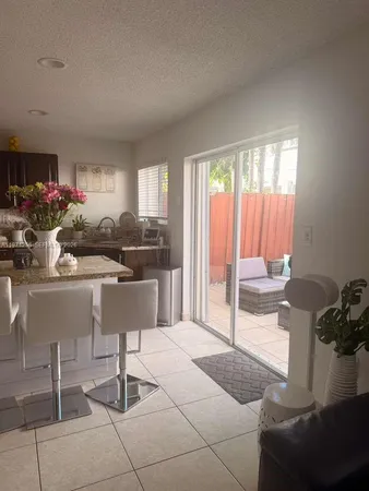 a living room with furniture and a floor to ceiling window