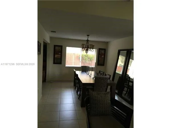 a view of a dining room with furniture and window