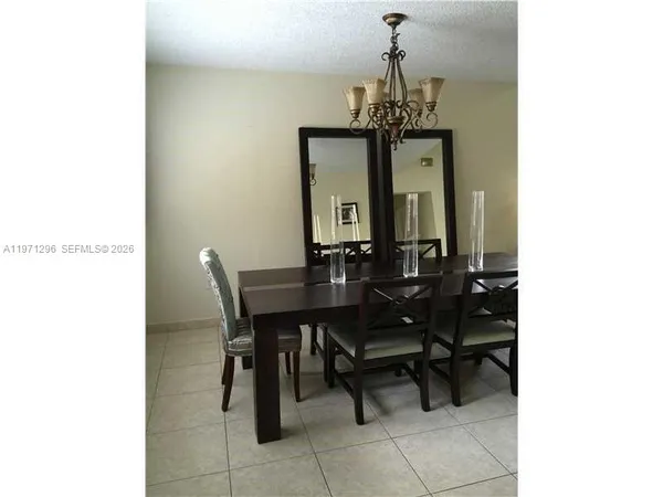 a view of a dining room with furniture and a chandelier