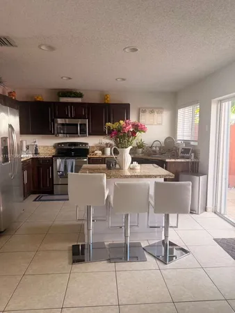 a kitchen with stainless steel appliances granite countertop a sink and cabinets