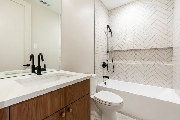 a bathroom with a sink a toilet and a bathtub
