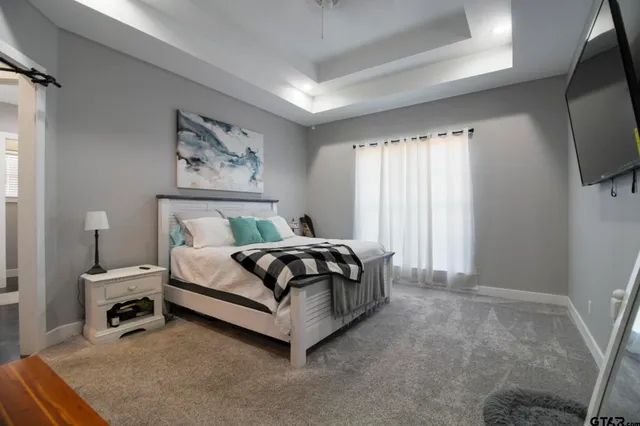 a bedroom with a bed and a flat screen tv