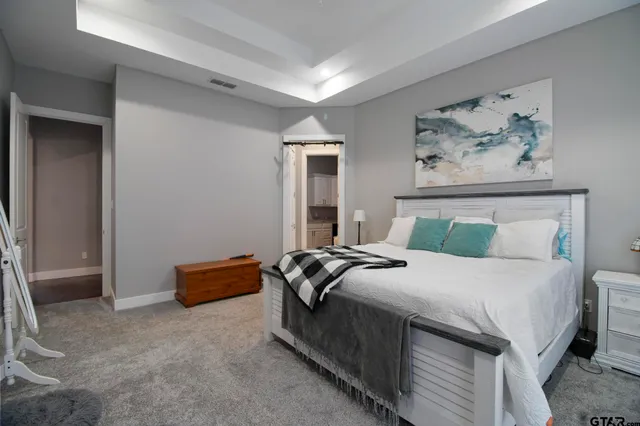 a bedroom with a bed and a painting on the wall