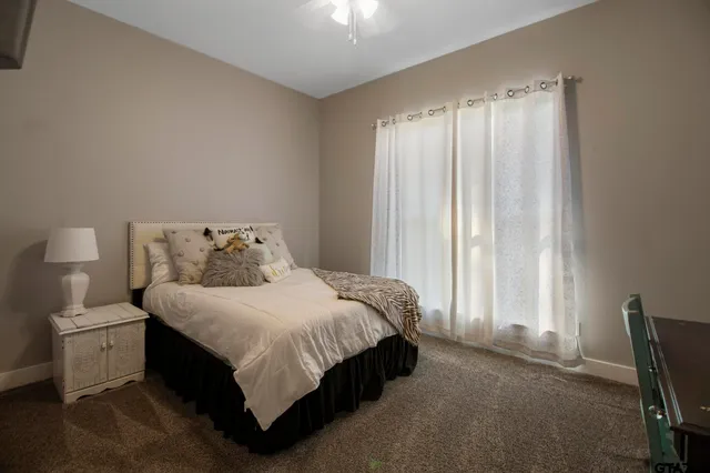 a spacious bedroom with a bed and a window