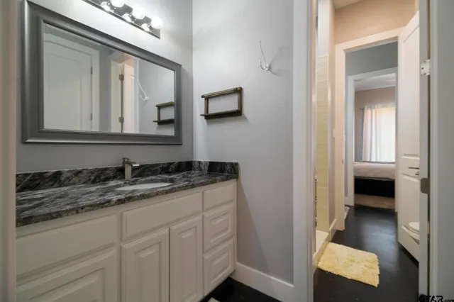 a en suite bathroom with a sink and a mirror