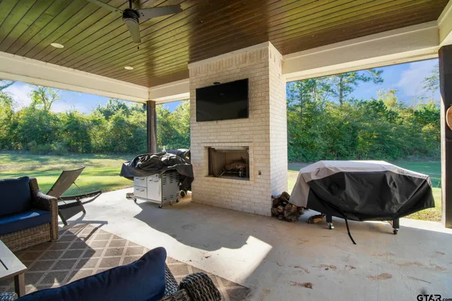a view of a patio with a table chairs and a swimming pool