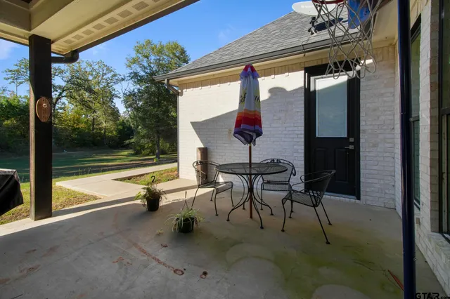 a view of a patio with a table and chairs