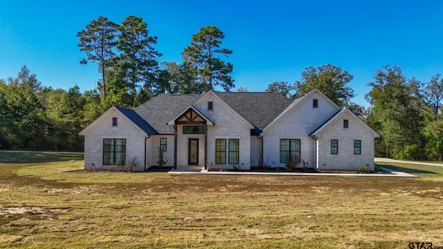 a house with a large pool in front of it