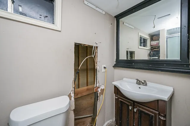 a bathroom with a sink a toilet and a mirror